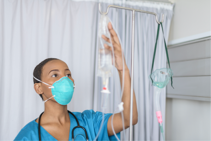 A nurse checking an IV bag